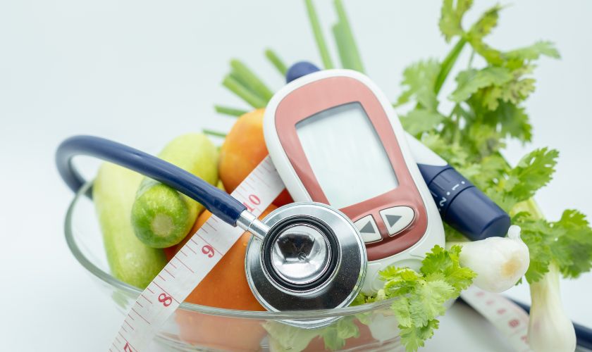 bowl of vegetables with a stethoscope pen tape and blood glucose meter bowl of vegetables with a stethoscope pen tape and blood glucose meter