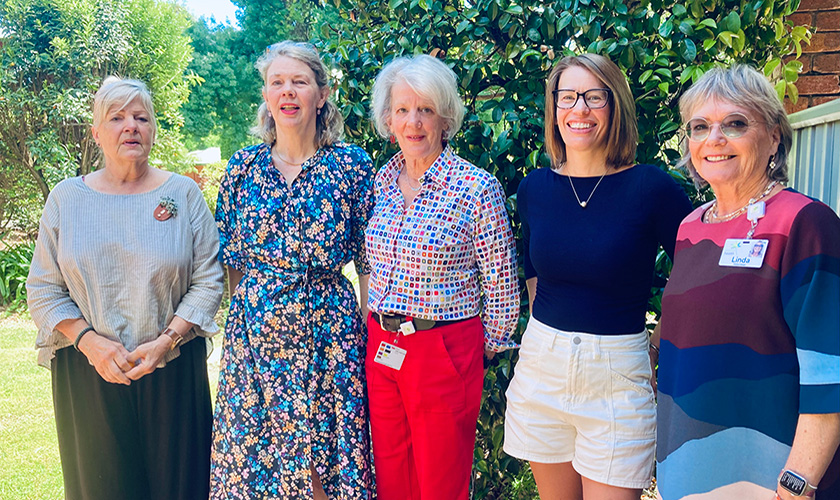 a group of five people standing together