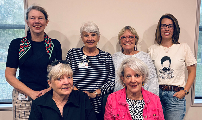 A group of women standing together smiling