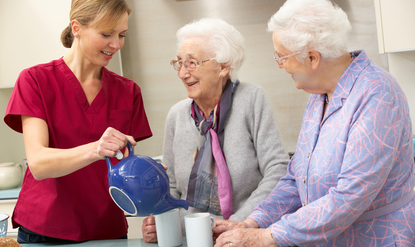 homecare support worker making tea for clients