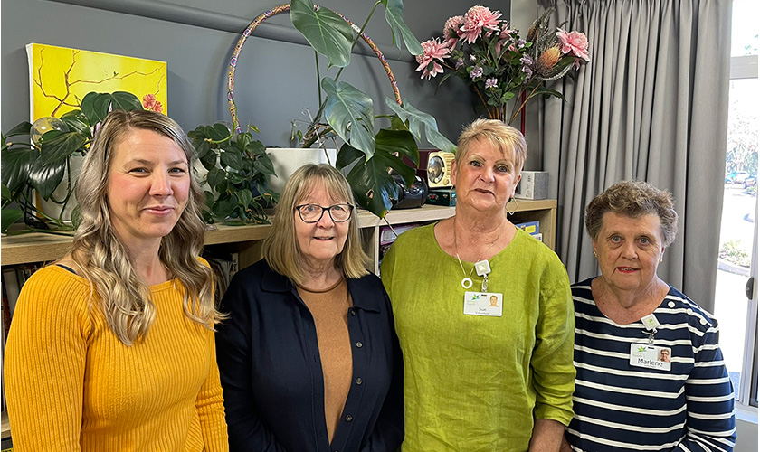 a group of women with Sue Nicoll standing together smiling a group of women with Sue Nicoll standing together smiling