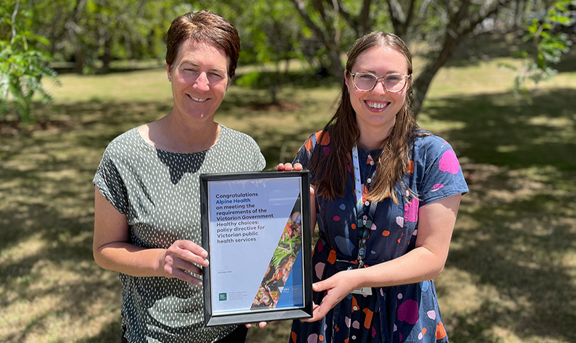 two people holding a certificate 