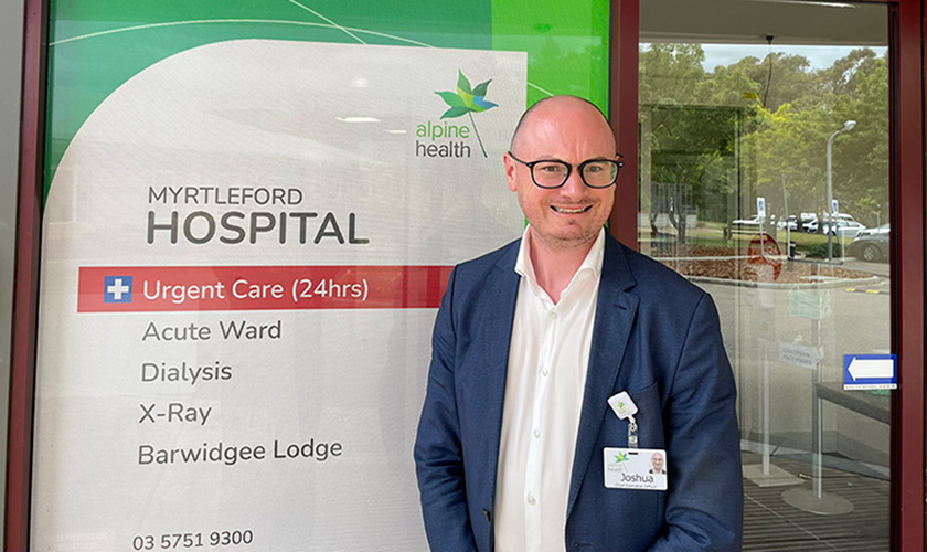a man standing in front of the Myrtleford Hospital main entrance