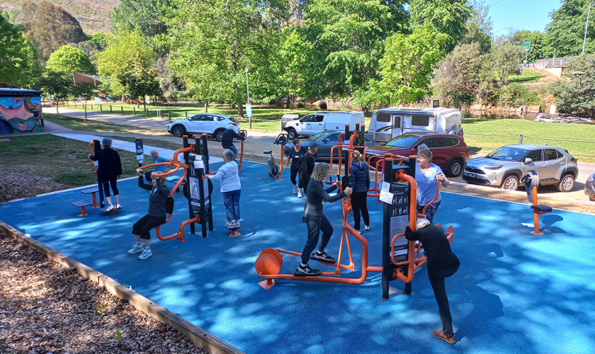 group of people using outdoor exercise equipment in porepunkah