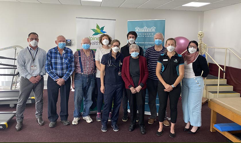 PACE participants wearing masks in a group with health staff 